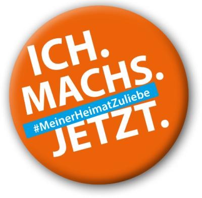 Orangener Badge mit Text: "Ich machs jetzt #MeinerHeimatZuliebe"